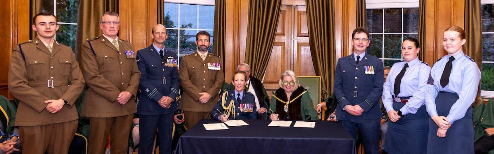 Image shows Deputy Master Liz Shilling with members of the military.